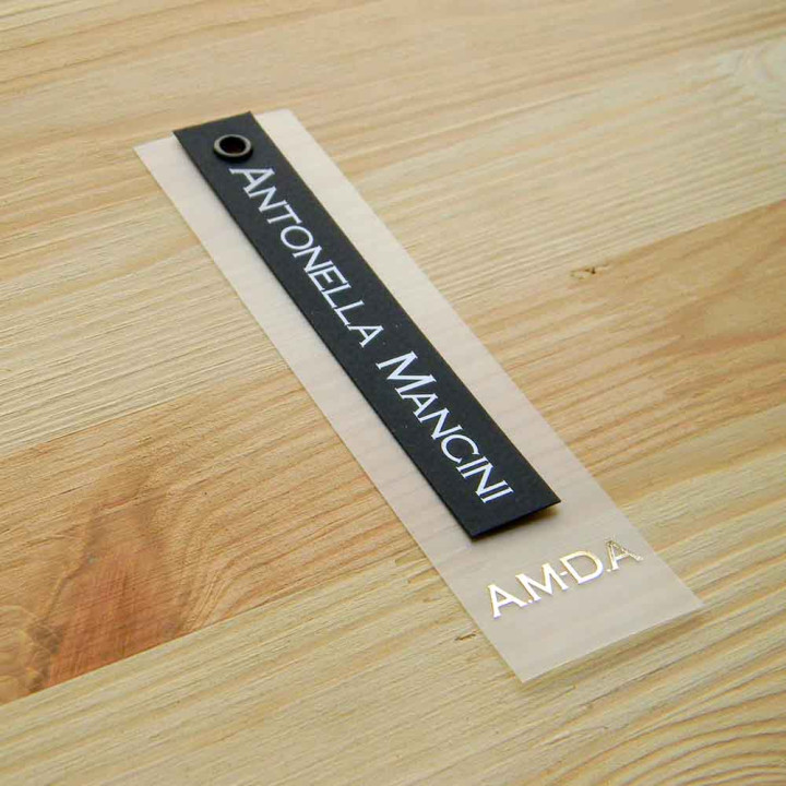 Plastic hanging label with cardboard and grommet "Antonella Mancini" 12,5x3 cm