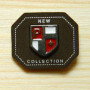 Leather label with metal "coat of Arms"